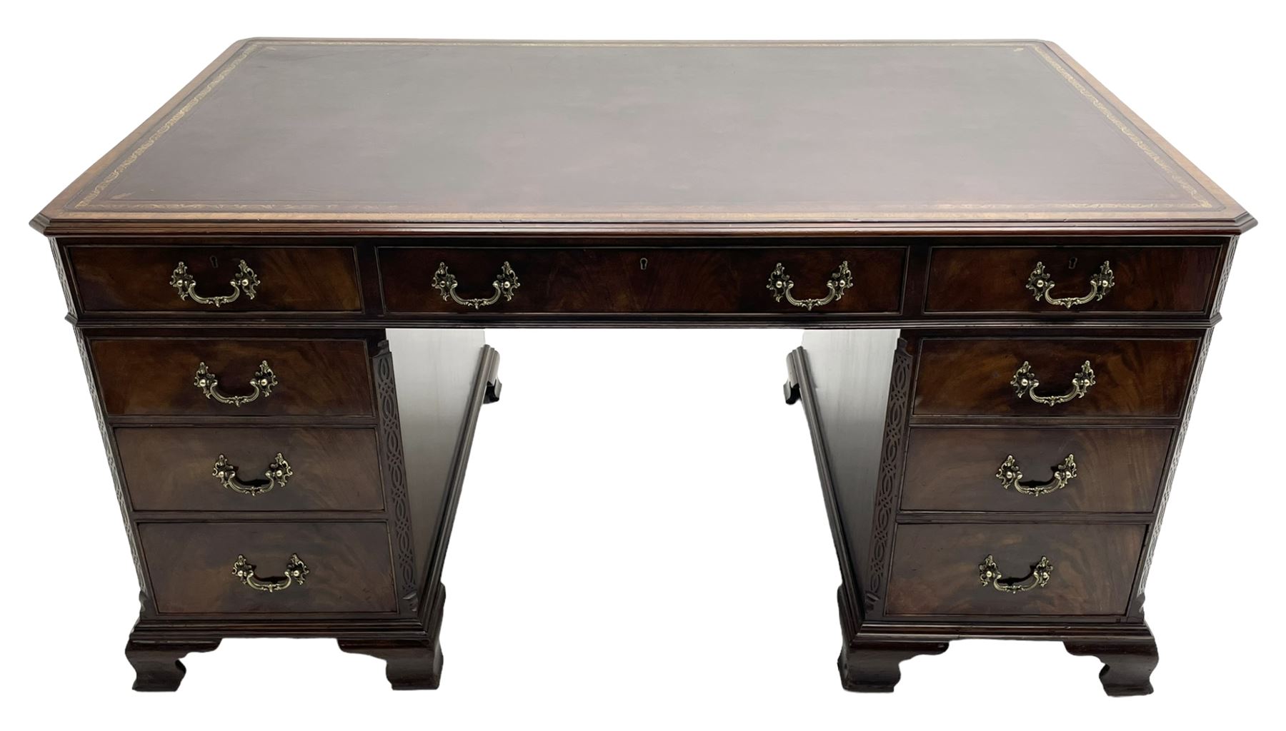 Large Georgian design mahogany twin pedestal partner's desk, moulded rectangular top with canted corners and inset leather writing surface, fitted with nine drawers and two cupboards, the pedestals with canted uprights decorated with blind fretwork, on ogee bracket feet