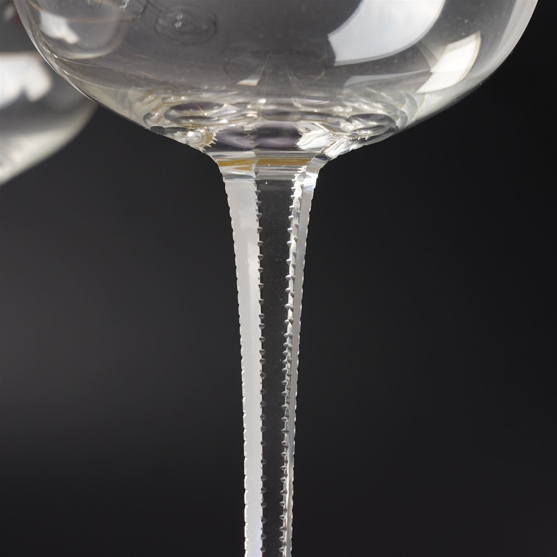 Set of six Wiener Werkstatte champagne coupe glasses, with gilt trimmed rim and foot, the faceted trumpet stem with toothed edges, H17cm 