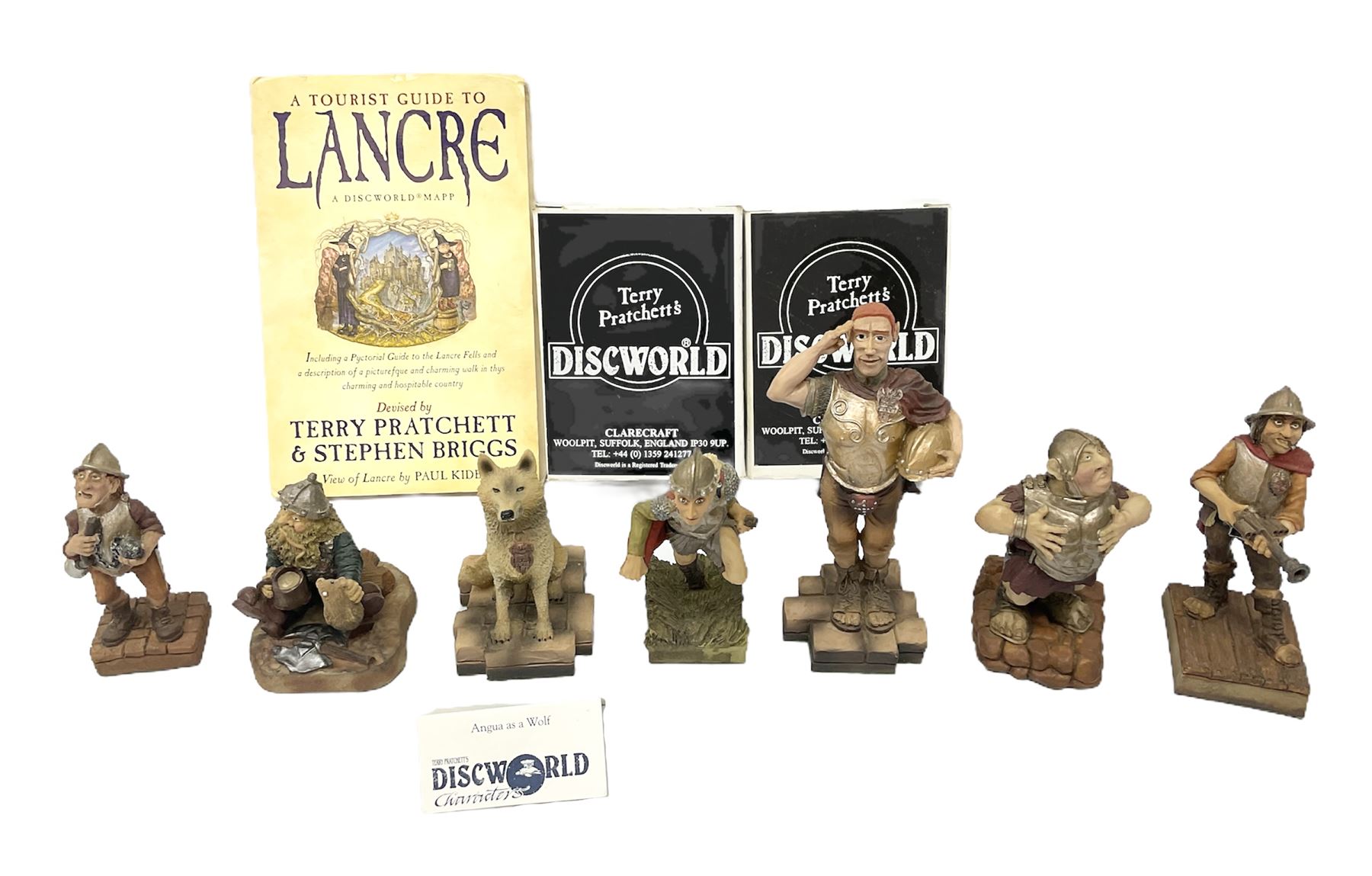Terry Pratchett Discworld figures, designed by Clarecraft, comprising Captain Vimes DW54, in box, Angua DW66, in box, Angua as a wolf DW102, Sergeant Colon DW30, Corporal Nobbs DW80, Captain Carrot DW100, Cuddy the Dwarf DW106, together with a Tourist Guide to Lancre a Discworld Mapp