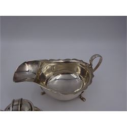 Group of silver, comprising 1930s sauce boat, of typical squat form with shaped rim, upon three pad feet, hallmarked Mappin & Webb Ltd, Birmingham, date letter indistinct, including handle H7cm, novelty Jersey/Guernsey milk can with cover, hallmarks worn and indistinct, H7cm, pair of Edwardian shell salts, with matching spoons, hallmarked Joseph Gloster Ltd, Birmingham 1905 and a pair of Victorian horseshoe place card holders, hallmarked Cornelius Desormeaux Saunders & James Francis Hollings (Frank) Shepherd, Chester 1900