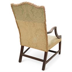 Georgian design mahogany framed Gainsborough armchair, arched cresting rail over shaped arms on curved and moulded supports, upholstered in pale green fabric with repeating foliate pattern, on square tapering moulded supports united by plain stretchers 