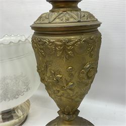 Gilt metal table lamp, heavily embossed with flowers and butterflies, with fluted frosted glass shade, H56cm