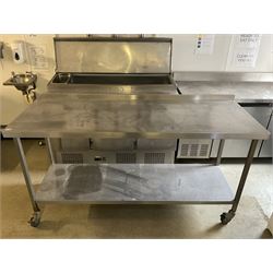 Stainless steel two tier preparation table, raised back, on castors- LOT SUBJECT TO VAT ON THE HAMMER PRICE - To be collected by appointment from The Ambassador Hotel, 36-38 Esplanade, Scarborough YO11 2AY. ALL GOODS MUST BE REMOVED BY WEDNESDAY 15TH JUNE.