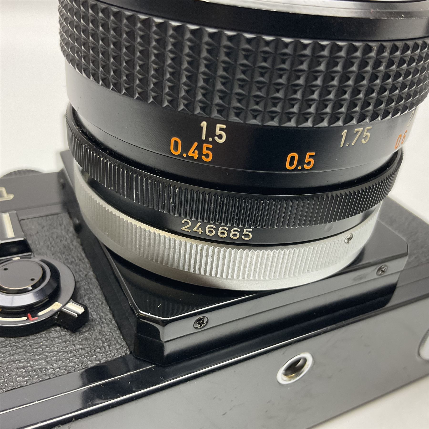 Canon F1n camera body, serial no. 572972, with 'Canon FD 50mm 1:1.4' lens, serial no. 246665, with leather case 