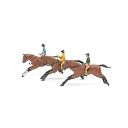Three early-mid 20th century carved and painted wooden jockeys on horseback, attributed to...