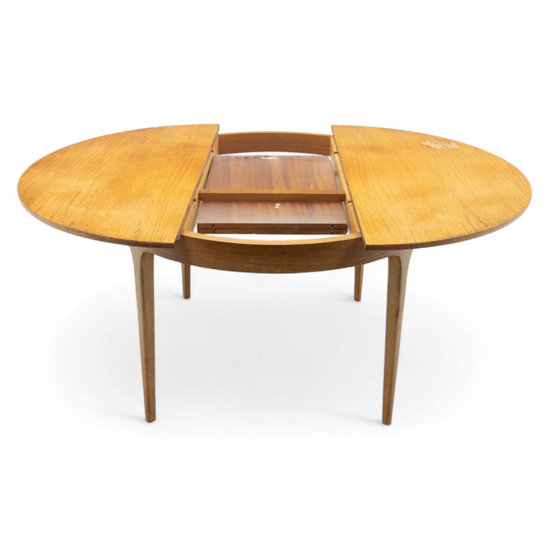 Sutcliffe of Todmorden - mid 20th century ‘S-Form’ teak dining table and chairs, the circular storable extending table with plain veneered top on tapered supports, together with matching dining chairs upholstered in black vinyl, with curved slat backs and shaped front supports, reflecting the sleek organic styling characteristic of 1960s British modern furniture design (Chairs H 93cm, W 46cm, D 46cm) (Extended 168cm)