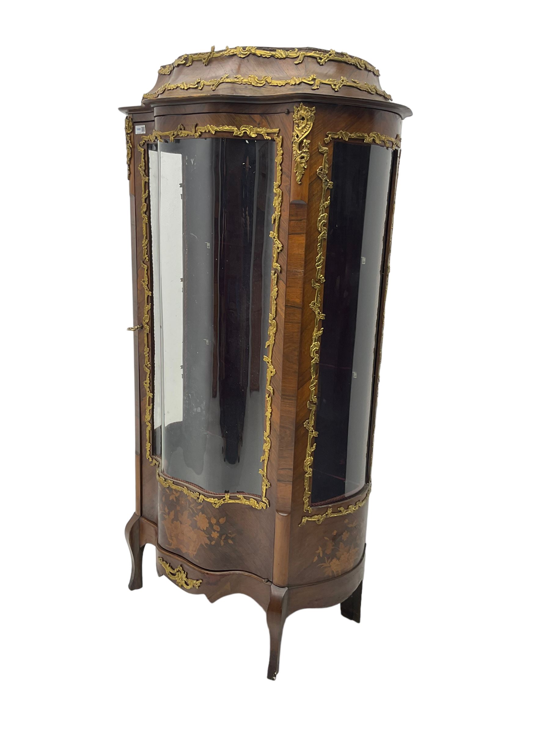 Early 20th century French kingwood vitrine or display cabinet, decorated with applied foliate cast band, serpentine glazed door and sides, inlaid with marquetry decoration of floral bouquets and branches, cartouche mounts to the apron, raised on cabriole supports