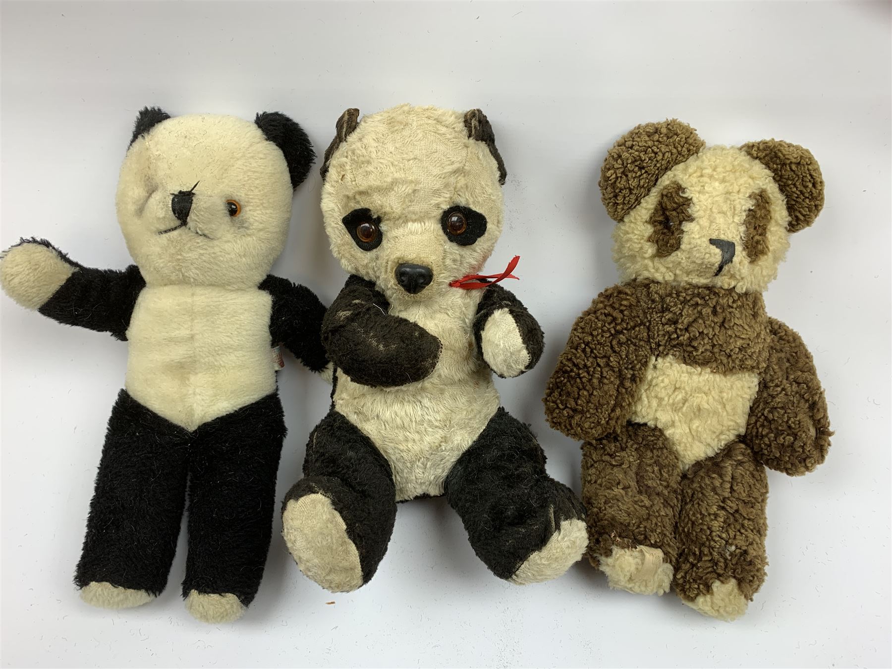 Seven English panda bears c1930s-50s including two Pedigree with plastic dog type noses H11.5