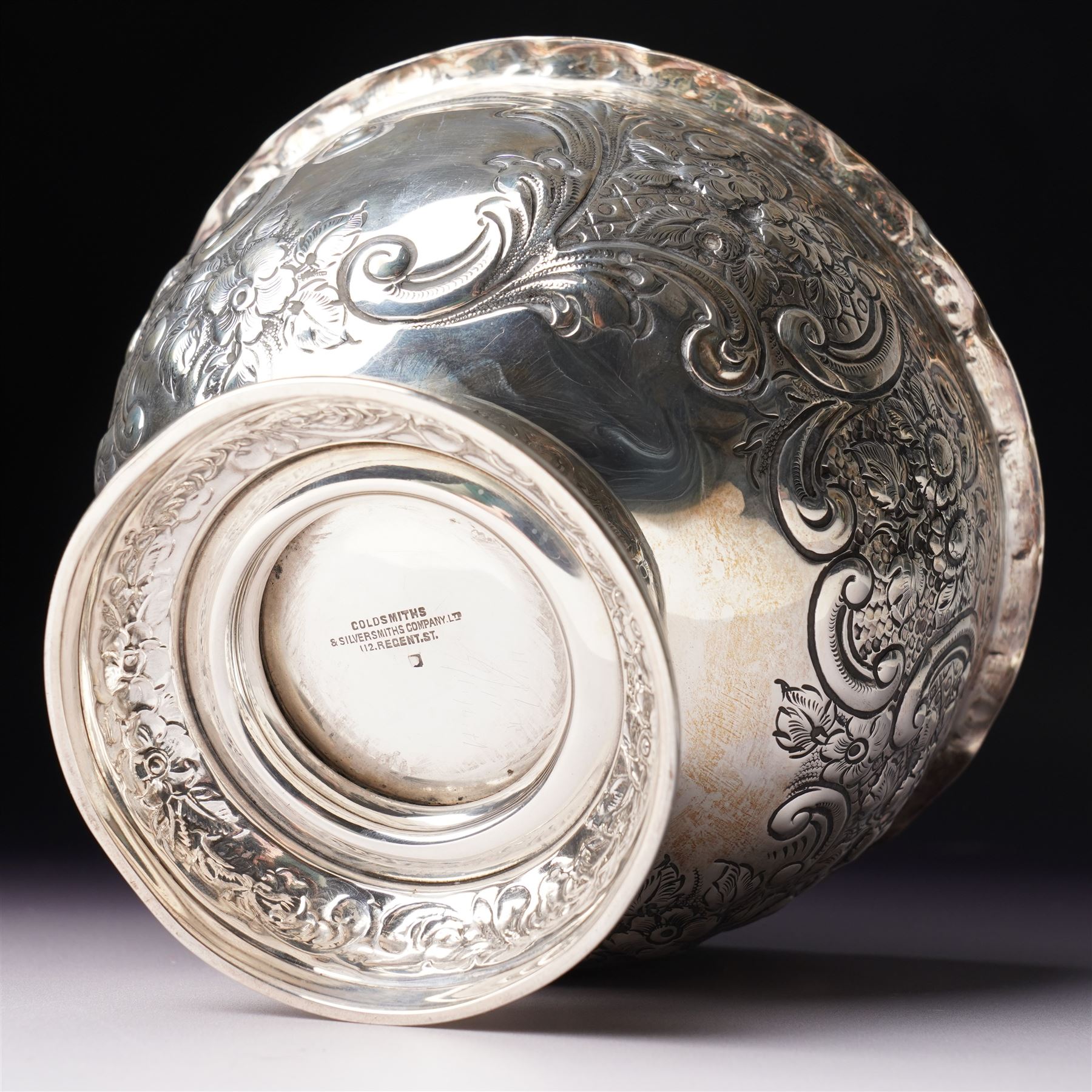 Late Victorian silver bowl embossed with flower heads and scrolls and with vacant cartouches on short pedestal foot D17cm London 1900 Maker Goldsmiths & Silversmiths Company