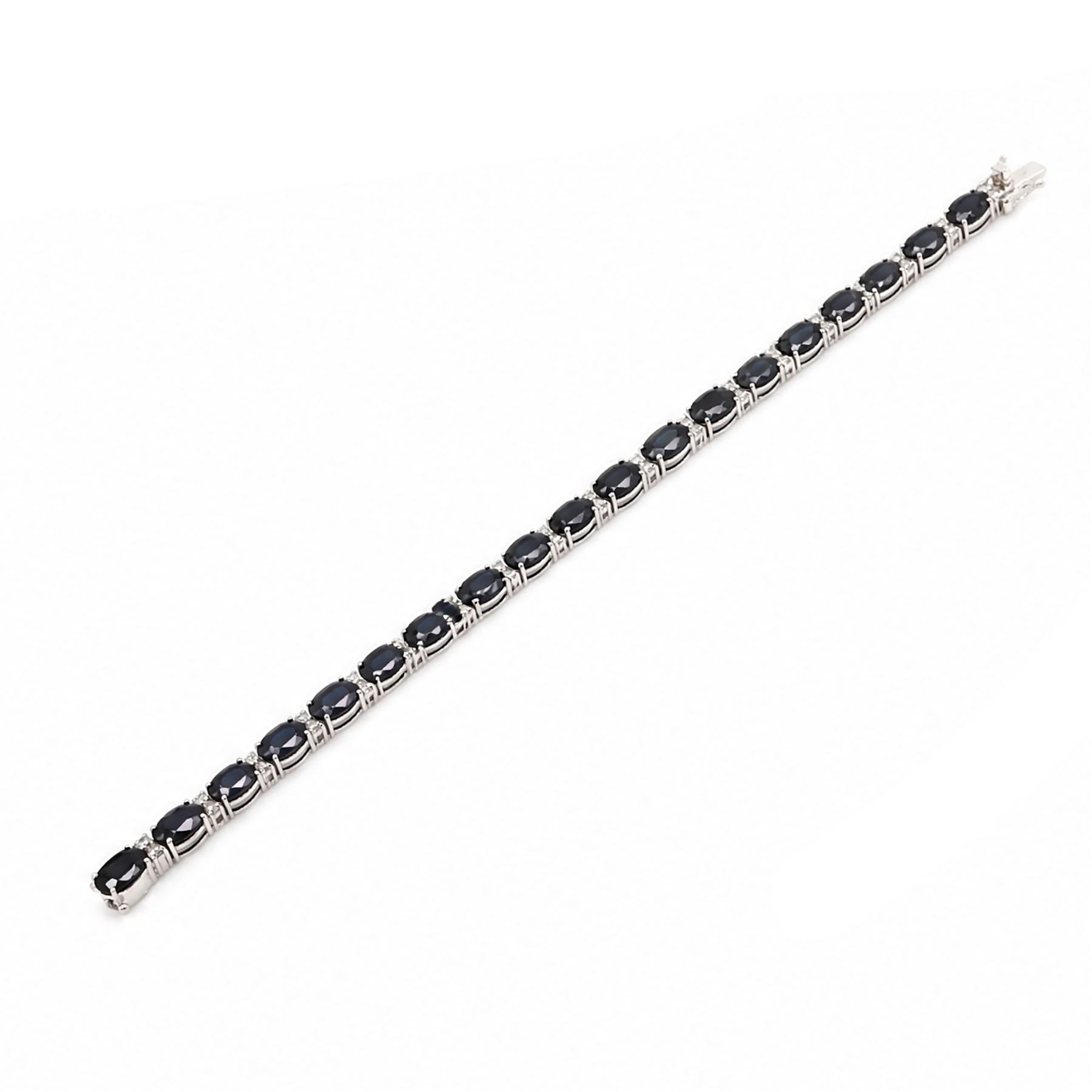 18ct white gold sapphire and diamond bracelet, twenty-three oval cut sapphires, each spaced by two round brilliant cut diamonds, stamped 750, total sapphire weight 14.00 carat, total diamond weight 0.88 carat
