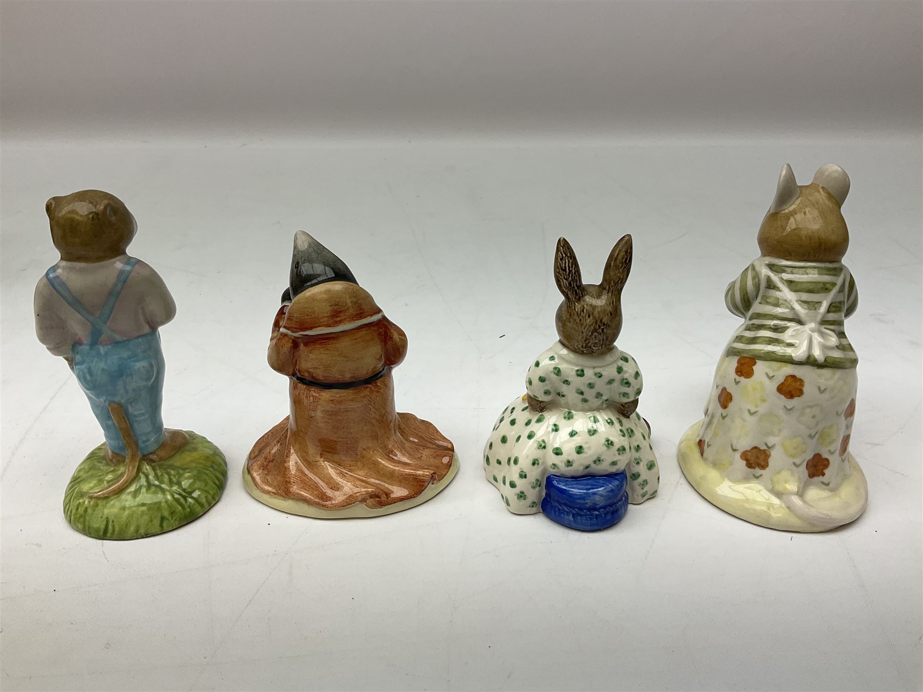 Fifteen Royal Doulton Brambly Hedge figures, comprising Wilfred Toadflax, Dusty Dogwood, Mrs Toadflax, Mr Apple, Primrose Woodmouse, Lord Woodmouse, Poppy Everbright, two Lady Woodmouse, two Old Mrs Everbright, Mr Toadflax, Mrs Apple, Santa Bunnykins and Bunnykins, together with three Royal Albert Wind in the Willows figures comprising Ratty, Badger and Mole, all with printed marks beneath (18)