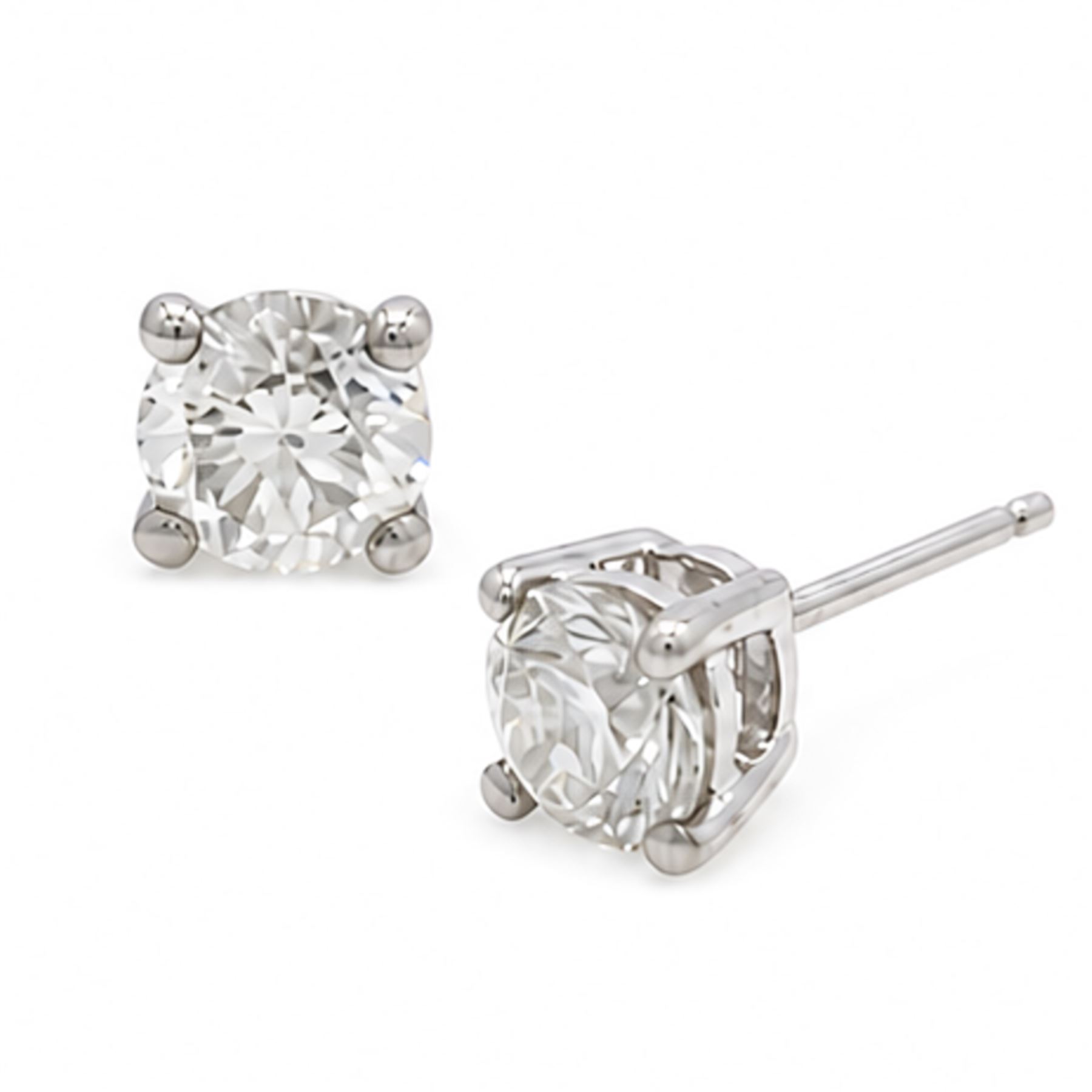 Pair of platinum diamond earrings, each stud set with a single round brilliant cut diamond, stamped PT 950total diamond weight approx 1.05 carat