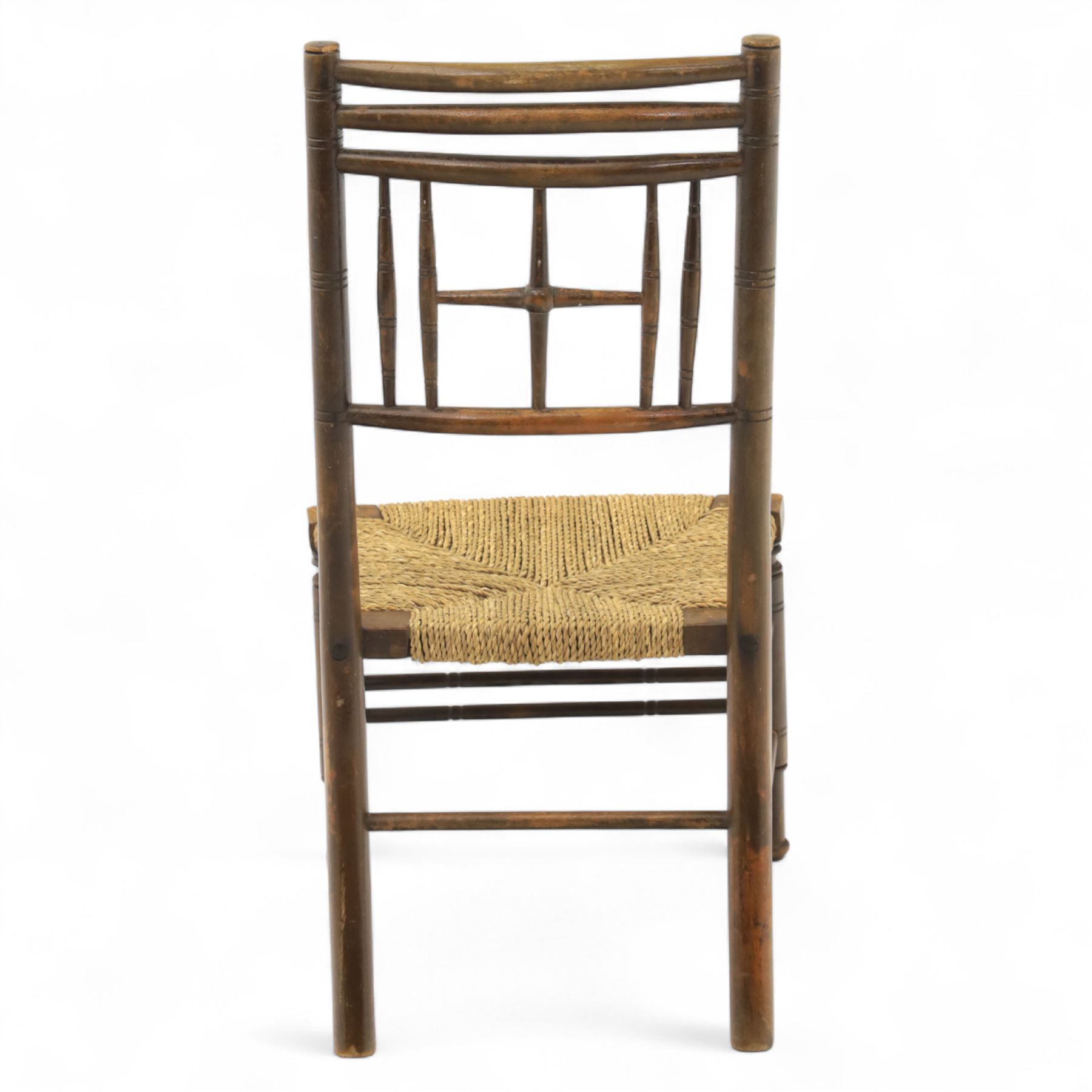 Ford Madox Brown, late 19th century Arts and Crafts child’s chair, with stained ash frame, triple curved top rails and turned spindle supports, the seat with woven rush, on turned legs united by front stretcher