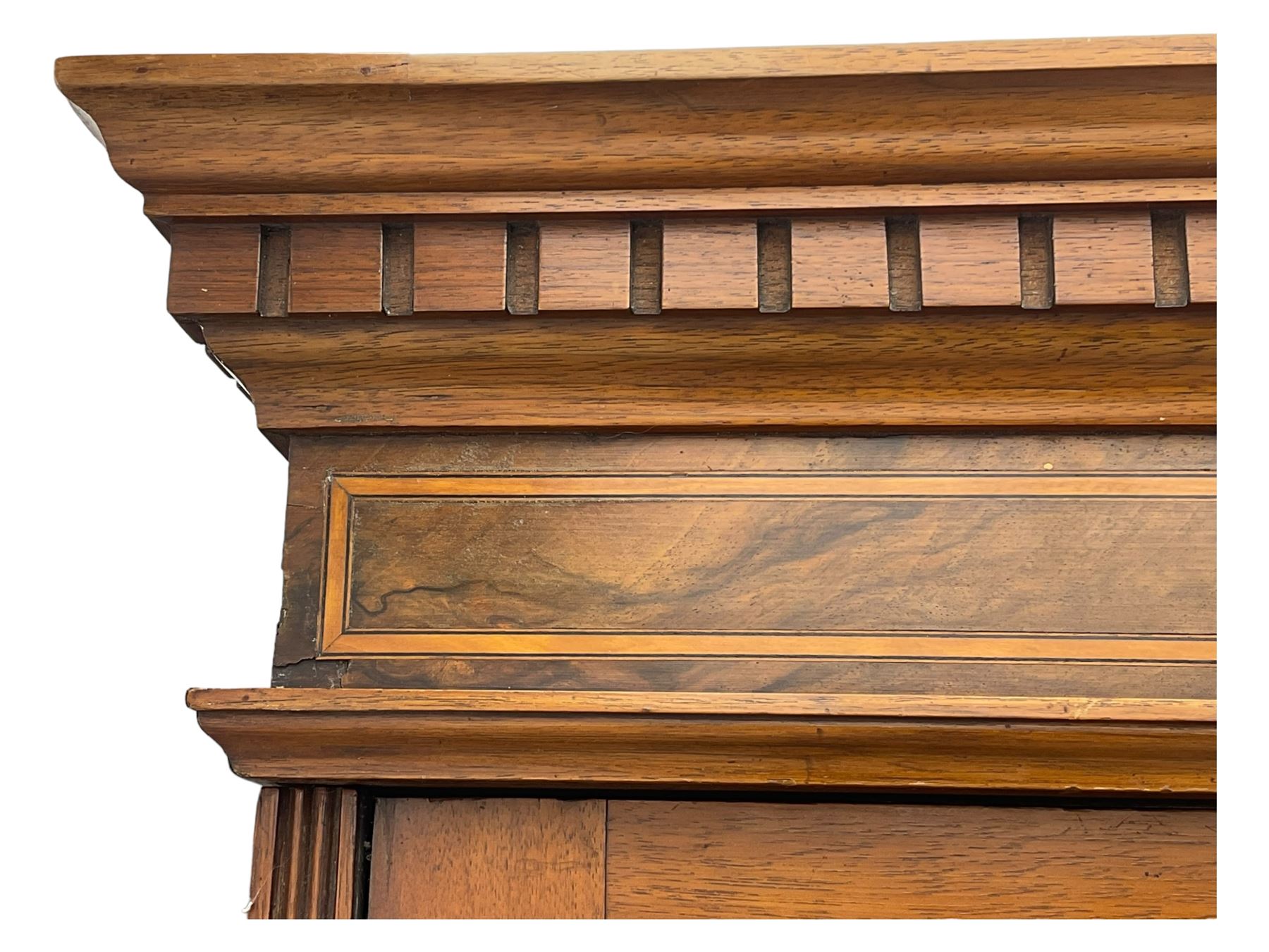 Late Victorian walnut triple combination wardrobe, projecting moulded and dentil cornice, central shaped bevelled mirror glazed door, cartouche and curled leaf carved panels over figured walnut veneered panels, fitted with drawer to base, on bracket feet