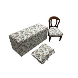 Ottoman blanket box upholstered in floral pattern fabric, matching bedroom chair and curtains