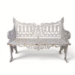 Victorian revival heavy cast iron garden bench, ornate back rest with scrolls, floral motifs and central crest, pierced lattice seat, curved arms and decorative legs, painted in antique white, in the Gothic Coalbrookdale style - Damaged 