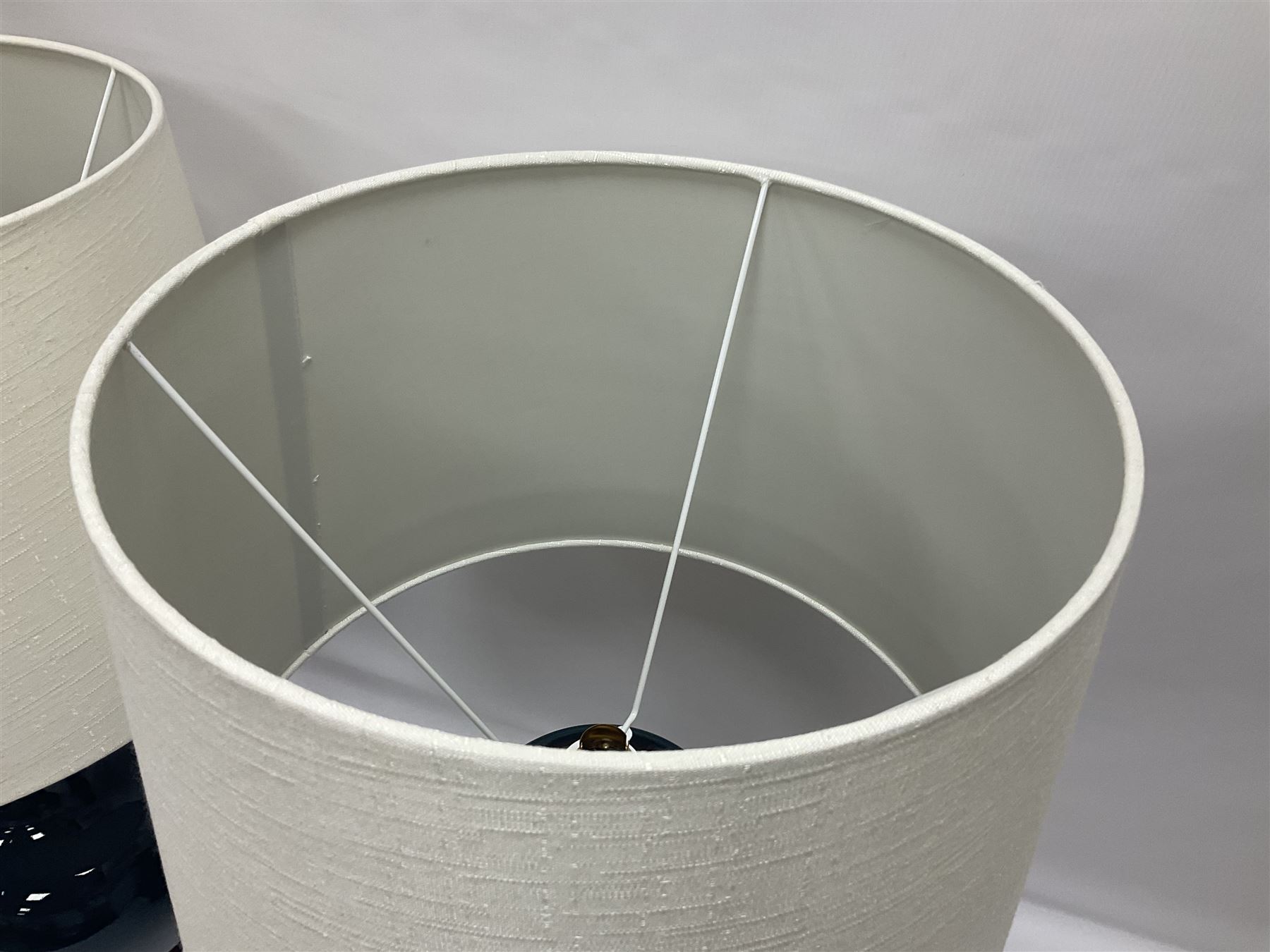 Pair of Chinese teal glazed table lamps, each of bottle form, raised upon circular hardwood bases, including shade H72cm 