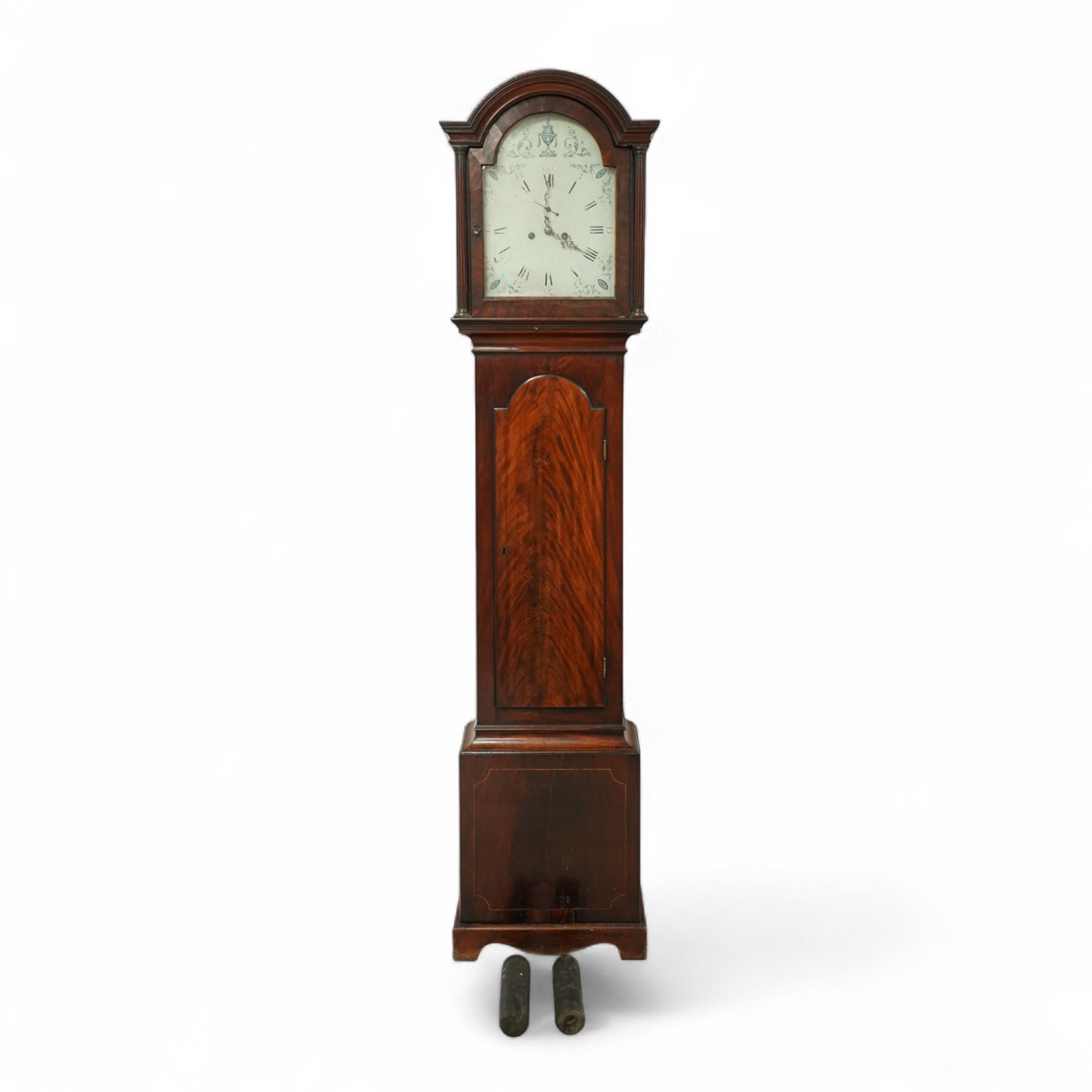 Late 18th century-8-day mahogany longcase clock c 1780, with a break arch pediment and conforming hood door beneath, door flanked by reeded capitals with brass capitals, plain mahogany trunk with a figured veneer door and break ach top, plinth with inlayed border raised on a shaped base, early painted dial with matching blue painted scroll spandrels and a depiction of a classical urn to the arch, with a subsidiary seconds dial, original steel hands, Roman numerals, five-minute Arabic's and minute markers, dial pinned via an early 