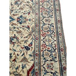 Fine Nain rug, ivory ground and decorated with pointed pole medallion, the field with interlacing branch and stylised plant motifs, decorated with birds, the border with repeating floral scroll design 