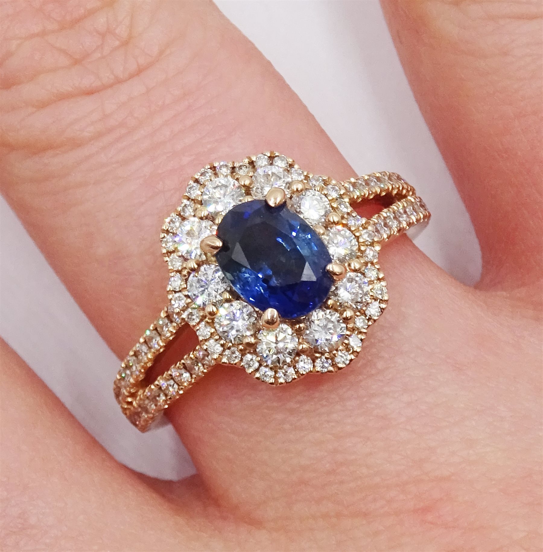 18ct rose gold oval sapphire and diamond cluster ring, with diamond set