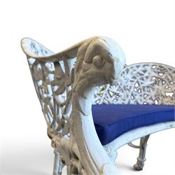 Victorian revival cast two seat garden bench, scrolling lattice back with flower heads, terminating to rams heads arms, curved pierced seat, finished in antique white paint