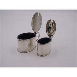 Victorian silver mustard pot, of oval drum form with beaded rim and scroll handle, the monogrammed cover with scroll thumbpiece lifting to reveal blue glass liner, including thumbpiece H6cm, hallmarked Henry Stratford, Sheffield 1887, together with a 1930's mustard pot of similar form with reeded border, shell thumbpiece, and blue glass liner, including thumbpiece hallmarked Birmingham 1936, maker's mark worn and indistinct, H5.5cm, approximate total silver weight 4.26 ozt (132.4 grams)