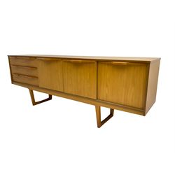 Stonehill Furniture (SF) Ltd - mid-20th century teak sideboard, rectangular topover three drawers, two cupboard doors and fall-front drinks cupboard, raised on square tapering supports