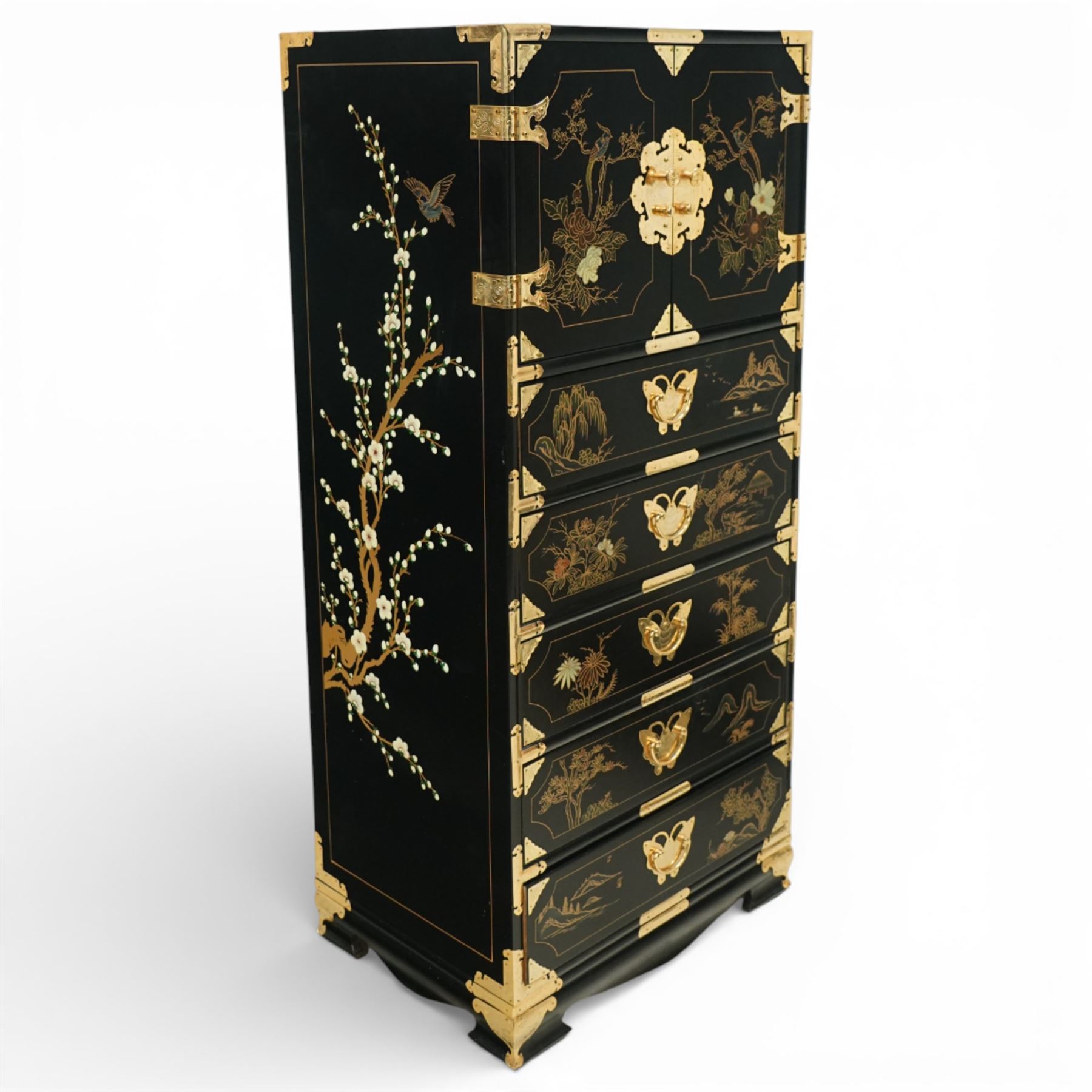 Japanese Shibayama style black lacquered curio chest, cupboard doors enclosing four short over two long fitted drawers, decorated in gilt with birds, flowers and landscape scenes, raised on gilt mounted bracket feet