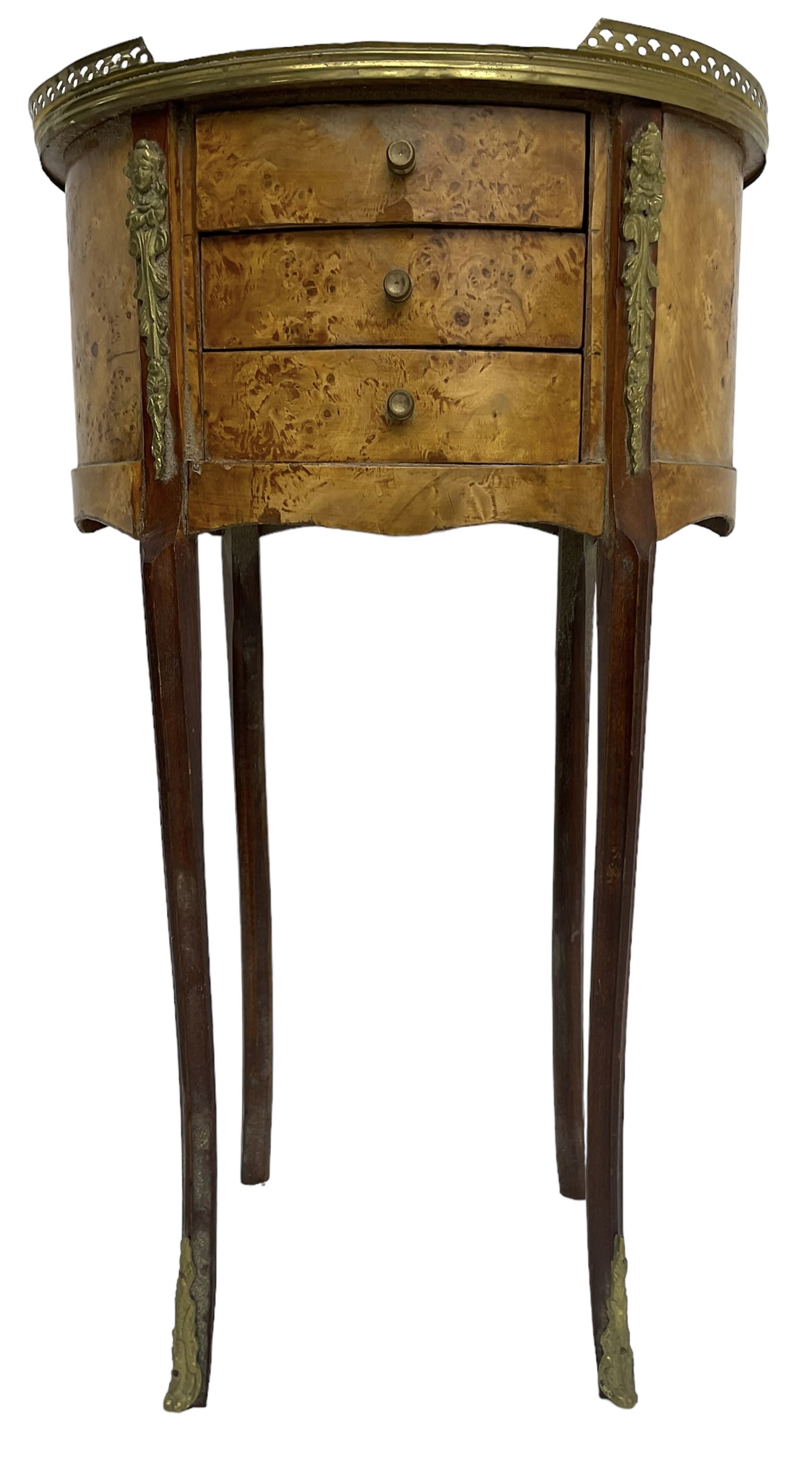 Late 20th century French design figured elm and bedside table, raised pierced gilt metal gallery over oval top, fitted with three mahogany lined drawers flanked by gilt metal mounts of female mask and foliate form, on cabriole supports