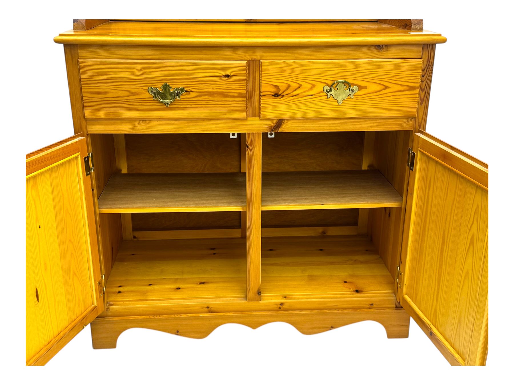 Victorian design pine dresser, projecting moulded cornice over scalloped frieze and two open shelves, base fitted with two drawers over double cupboard, on shaped plinth base