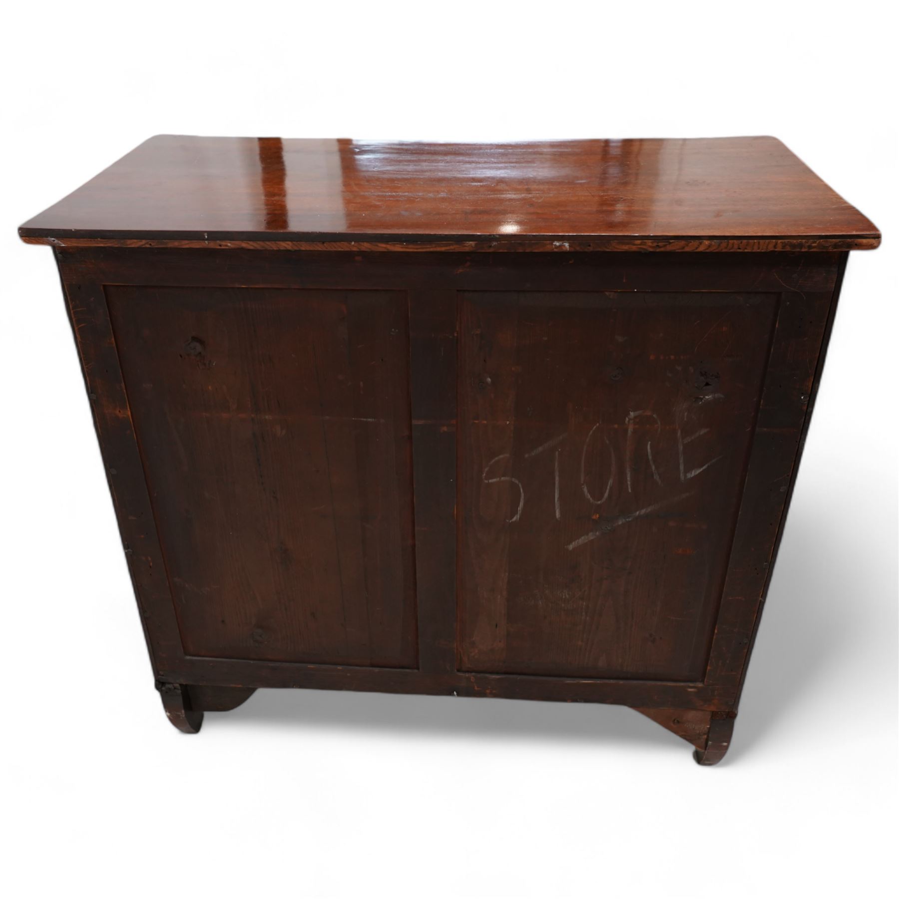 Regency mahogany cupboard, rectangular shaped top over two cock-beaded frieze drawers, fitted with brass Yorkshire rose pull handles, over two panelled and cross-banded cupboards, flanked by reeded uprights, raised on curved feet