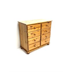 Polished pine chest fitted with eight drawers, turned supports