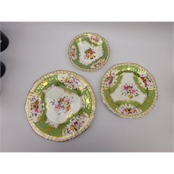 19th century English porcelain tea service, comprising teapot, thirteen teacups, eleven coffee cups, twelve saucers, twin handled sucrier and cover, slop bowl, and cream jug, decorated in pattern no 1923, with panels of floral sprays within gilt scrolling borders on an apple green ground