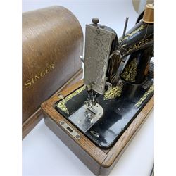 A cased vintage Singer hand crank sewing machine. 