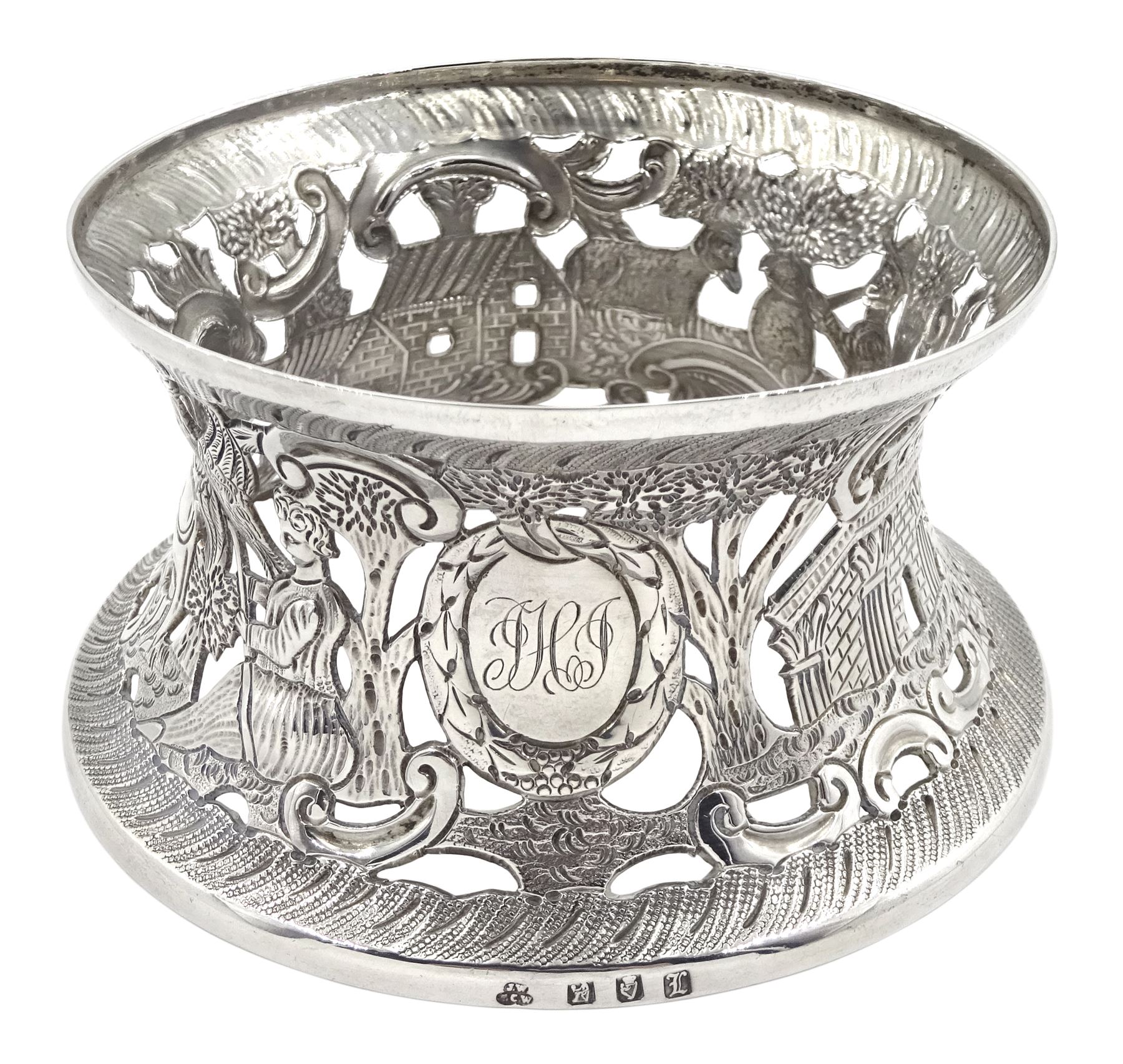 Edwardian Irish silver dish ring, of circular waisted form, embossed and pierced throughout with scene of figures, birds, cattle and buildings amidst C scrolls, hallmarked James Wakely & Frank Clarke Wheeler, Dublin 1906, upper rim D10cm, approximate weight 4.11 ozt (128 grams)