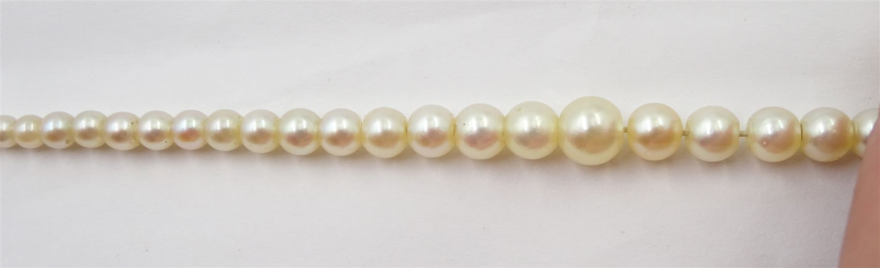 Three strand pearl necklace, with platinum diamond milgrain clasp and a single strand graduating pearl necklace with 18ct white gold clasp set with a diamond