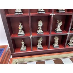 Danbury Mint 'The Fantasy of the Crystal' chess set consisting of mythical pewter chess pieces within a wooden case with chess board lid, together with 16 additional chess pieces in a wooden display case.