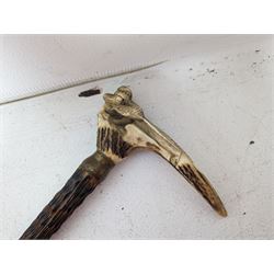 Walking stick with carved monkey handle, glass shooting flask in the form of a cartridge, bullet casings and other collectables