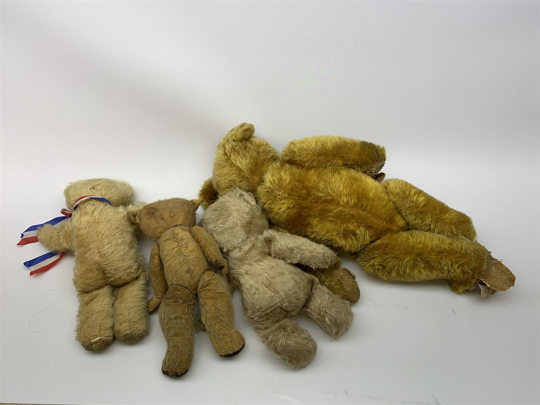 Three 1950s teddy bears including Chiltern dog type looking baby bear with tail, circular felt nose and stitched mouth and jointed limbs H15