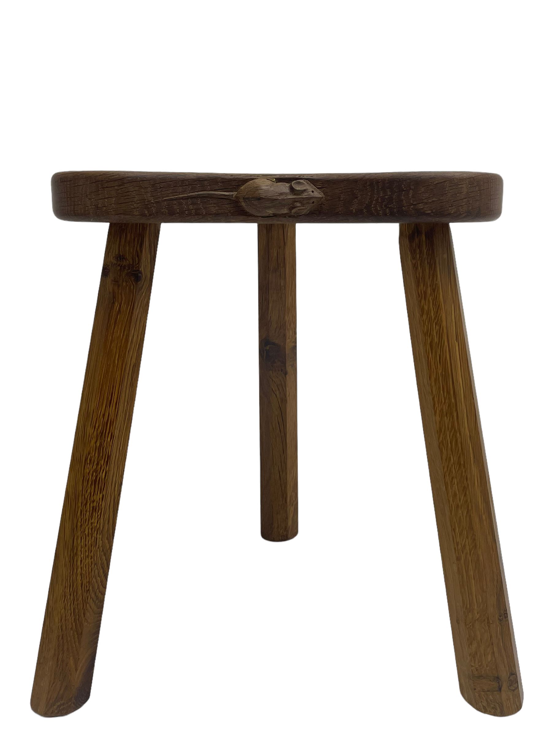 'Mouseman' oak three-legged stool, kidney shaped dished seat carved with mouse signature to edge, by Robert Thomas of Kilburn