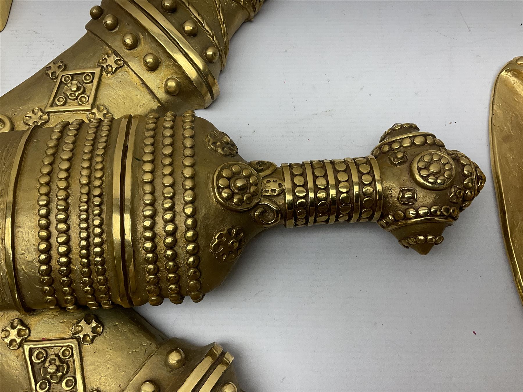 Gilt state emblem for Oman, a sheathed khanjar dagger superimposed above pair of crossed swords and belt and a seperate crown, main emblem H84cm, W83cm, crown H35cm, W33cm
Provenance by vendor repute: The emblem was previous mounted above HM's throne, in the main majalis, of the HM Royal Yacht AL Said, until 1985 when HM Sultan Qaboos ordered the upgrading of all state emblems, The emblem was gifted to the vendor who worked for the Sultans Royal Yacht Squadron