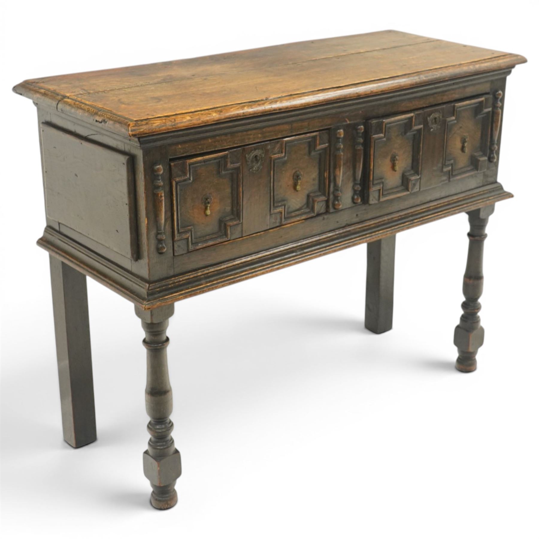 Georgian oak dresser base, plank top above an arrangement of two fielded panel drawers with moulded geometric fronts, on turned front supports and block rear legs