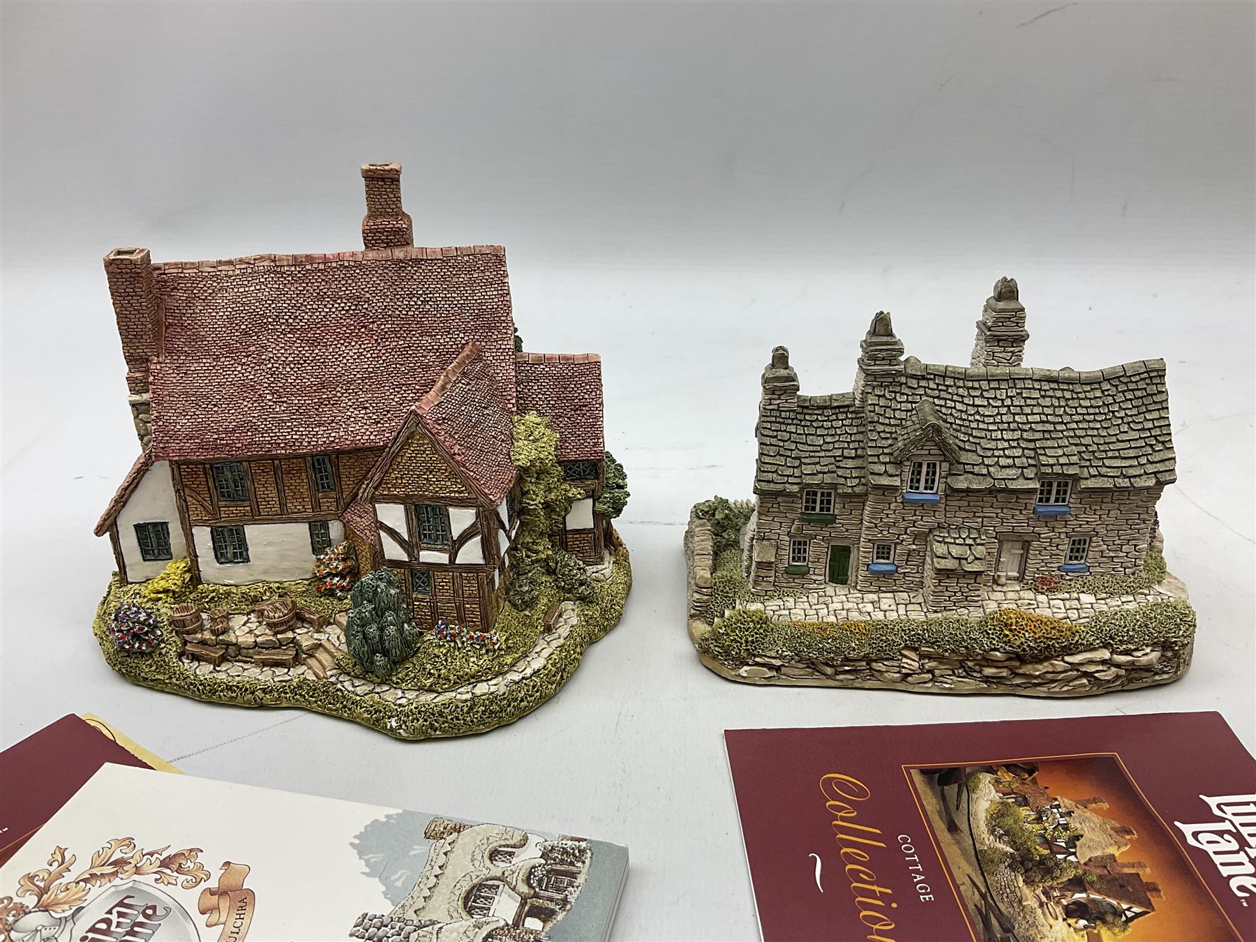 Nine Lilliput Lane cottages from the British and English collections to include Crown Inn, Wealden House, Puffin Row, etc, all boxed, one without deeds