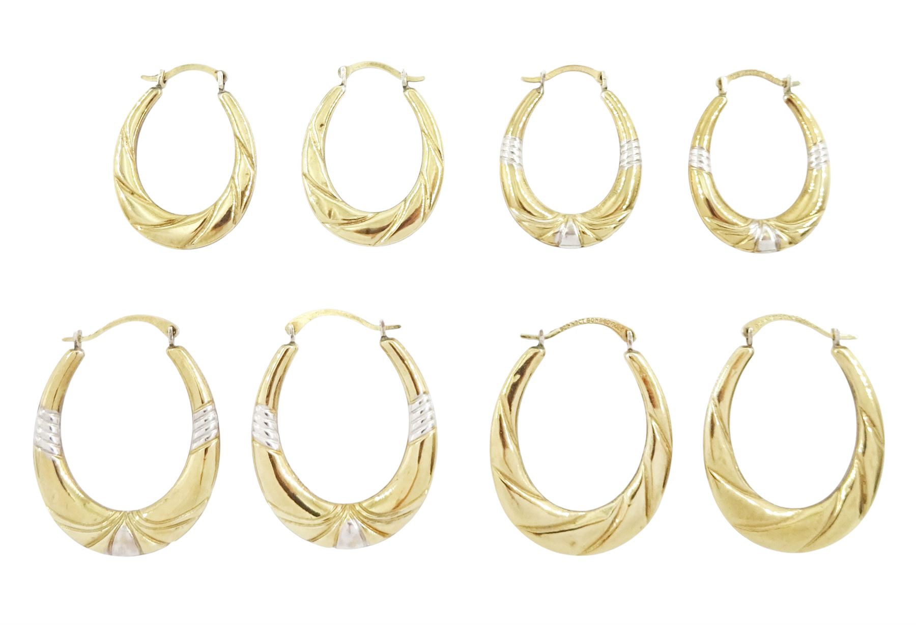 Four pairs of silver-gilt hoop earrings