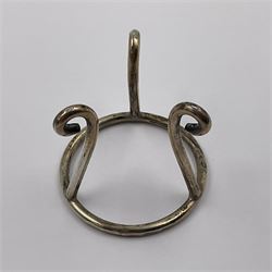 Modern silver limited edition Easter egg, no. 70/500, the gilt openwork body decorated with daffodils and detachable cover with pierced circular panel set with a single faceted blue stone, opening to reveal a gilt interior, upon silver stand with three scrolling pad feet, each hallmarked St James House Company, London 1980, height including stand 8cm