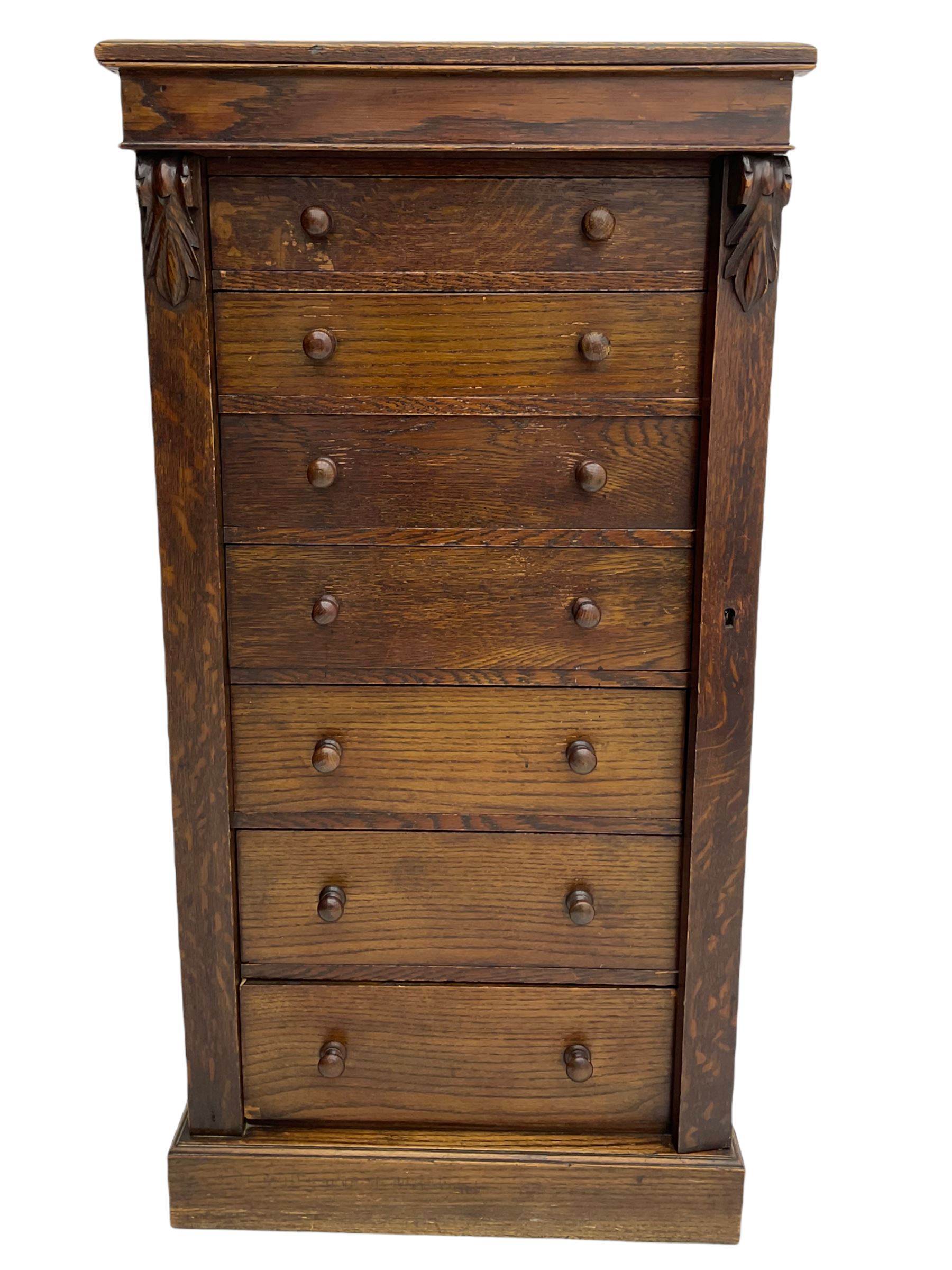 Victorian oak Wellington chest, fitted with seven drawers, lockable hinged side return