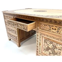 Large eastern hardwood desk, heavily carved with floral detailing shaped supports