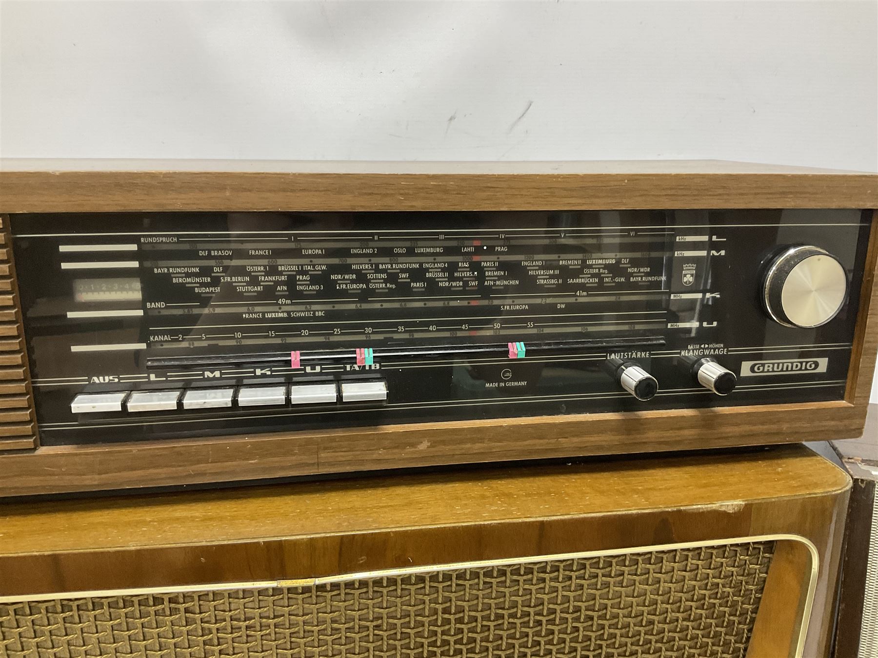 Three mid 20th century radios comprising 1950s Grundig wood cased valve radio model 3028/GB, together with a 1970s Grundig Type RF 153 CS 150 radio in teak case, and an Ekco 355 1960's valve radio, largest W60 H35cm D23cm