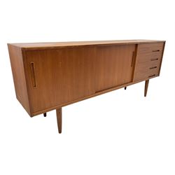 Nils Jonsson - mid-20th century teak sideboard, rectangular top over three-section base, left and centre sections with sliding double doors enclosing shelving, right section with four drawers, raised on tapered supports