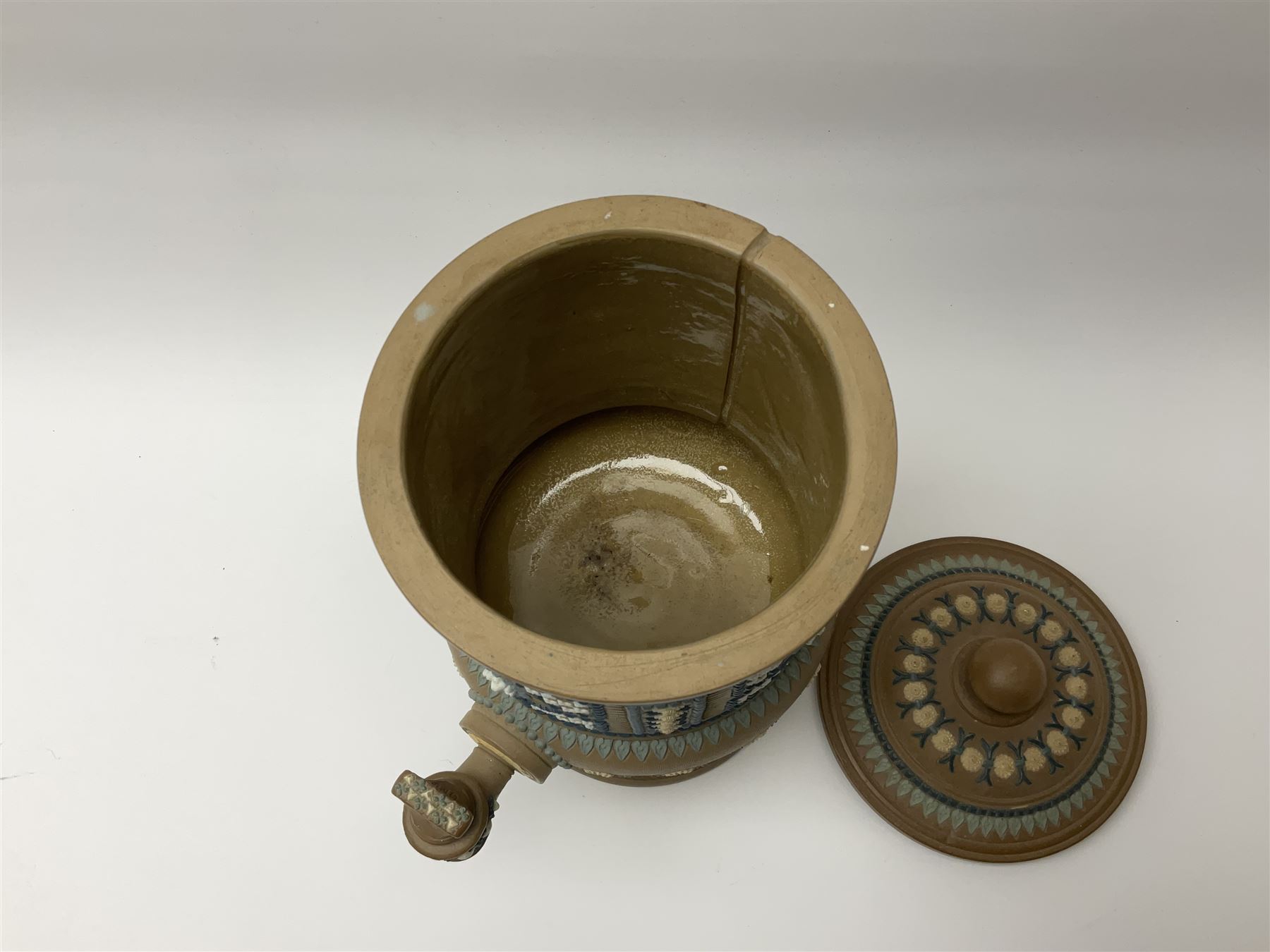 A late 19th century Doulton Lambeth stoneware water filter with original spigot, decorated with relief moulded foliate bands, with impressed marks and monogrammed for Laura Gooderham beneath, H34cm. 